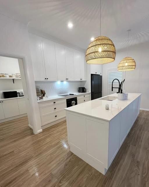 Kitchen with pendant lights and recessed ceiling lighting